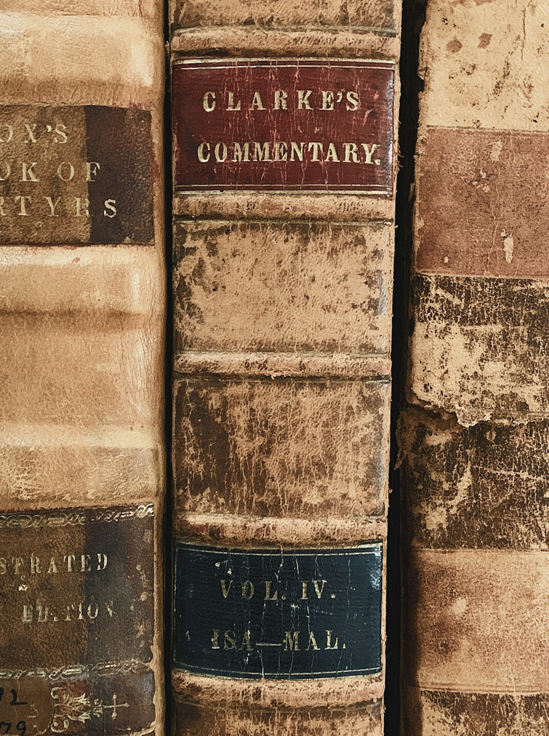 Stack of old books with worn spines